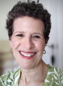 Photo of smilng woman with short curly hair